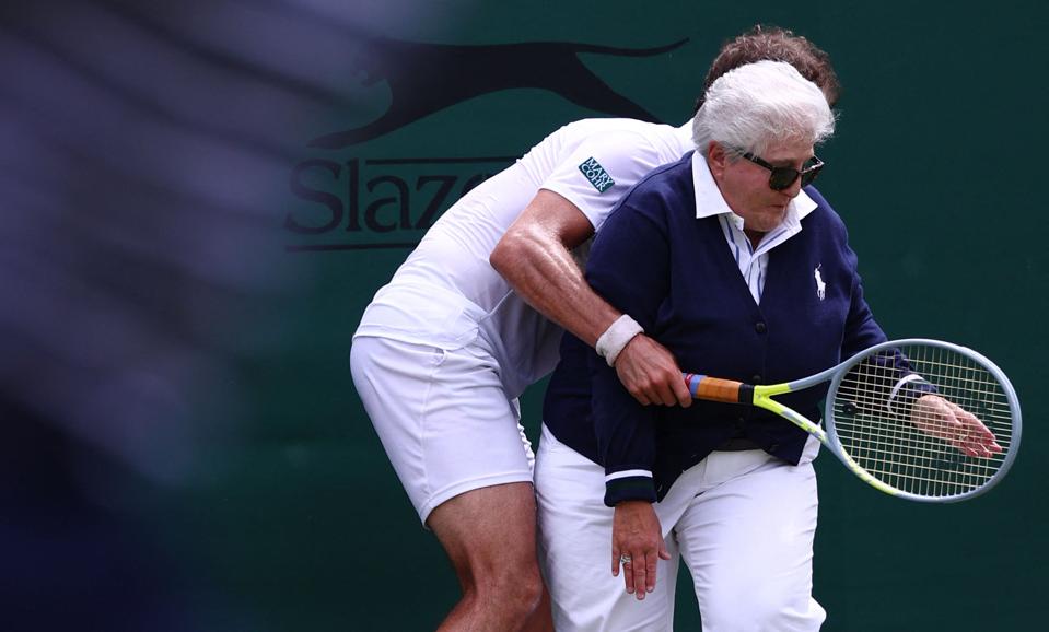 Richard Gasquet bumps into a line judge at the 2022 Wimbledon Championships.
