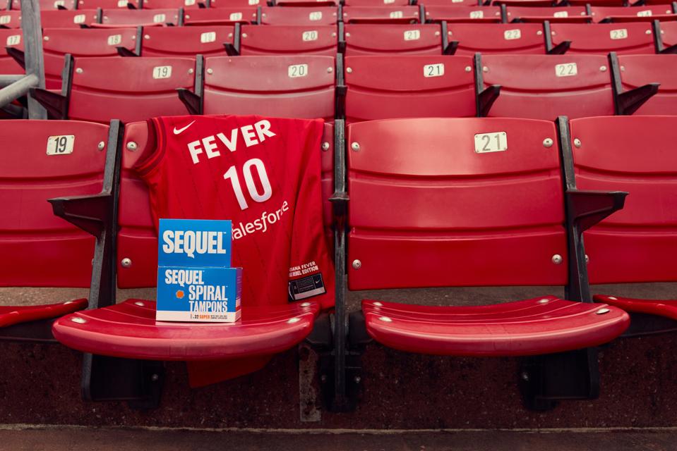 Sequel tampons featured on a stadium seat alongside Indiana Fever jersey.