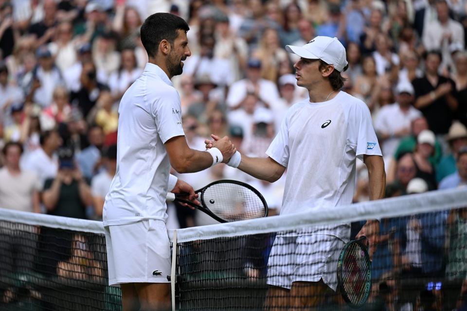 Novak Djokovic commiserates with Alex de Minaur after beating the Australian at Wimbledon.