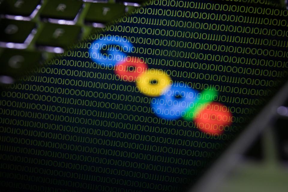 Google logo against backdrop of binary code on Android phone.