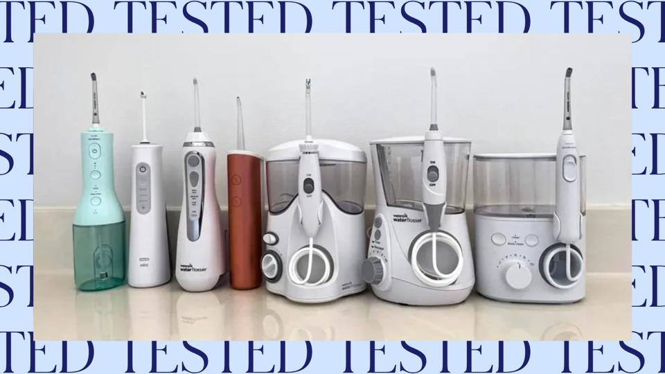 Seven water flossers sitting on a countertop