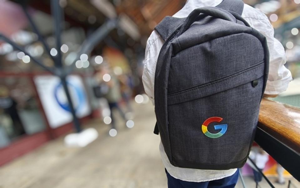 A man wearing a Google Cloud backpack.