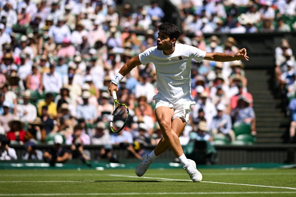 Carlos Alcaraz hits a floated shot during his Wimbledon semifinal against Taylor Fritz.