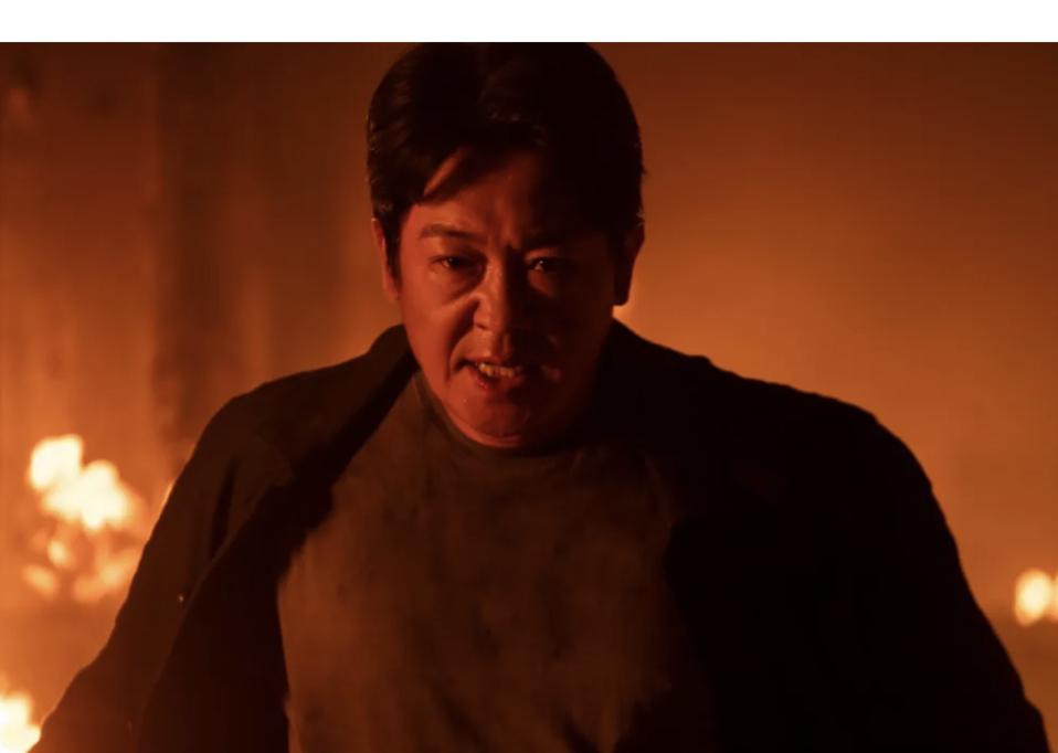 A man stands in the middle of a fire.