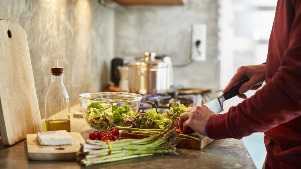 Midsection of man cutting vegetables