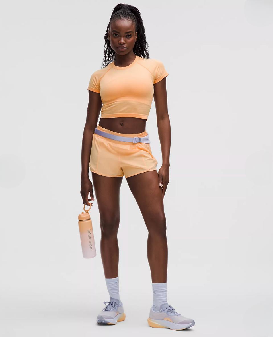 Model wearing Lululemon Hotty Hot High-Rise Lined Short in Rock Melon.