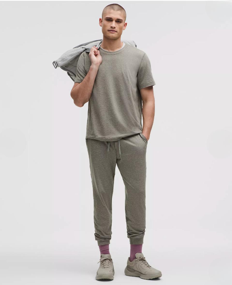 Model wearing Lululemon Soft Jersey Short-Sleeve Shirt in Heathered Grey Sage/Grey.