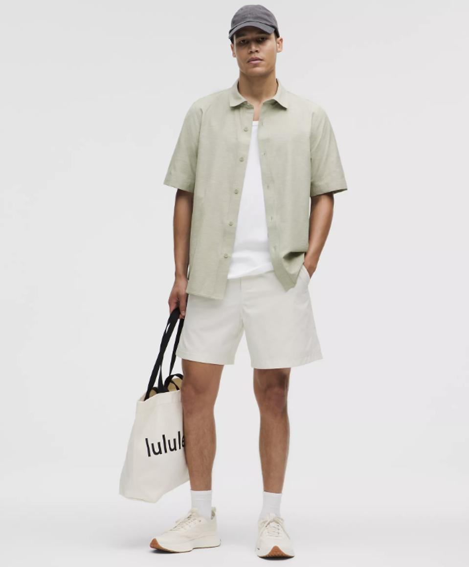 Model wearing Lululemon LuluLinen Short-Sleeve Shirt in Fog Green.