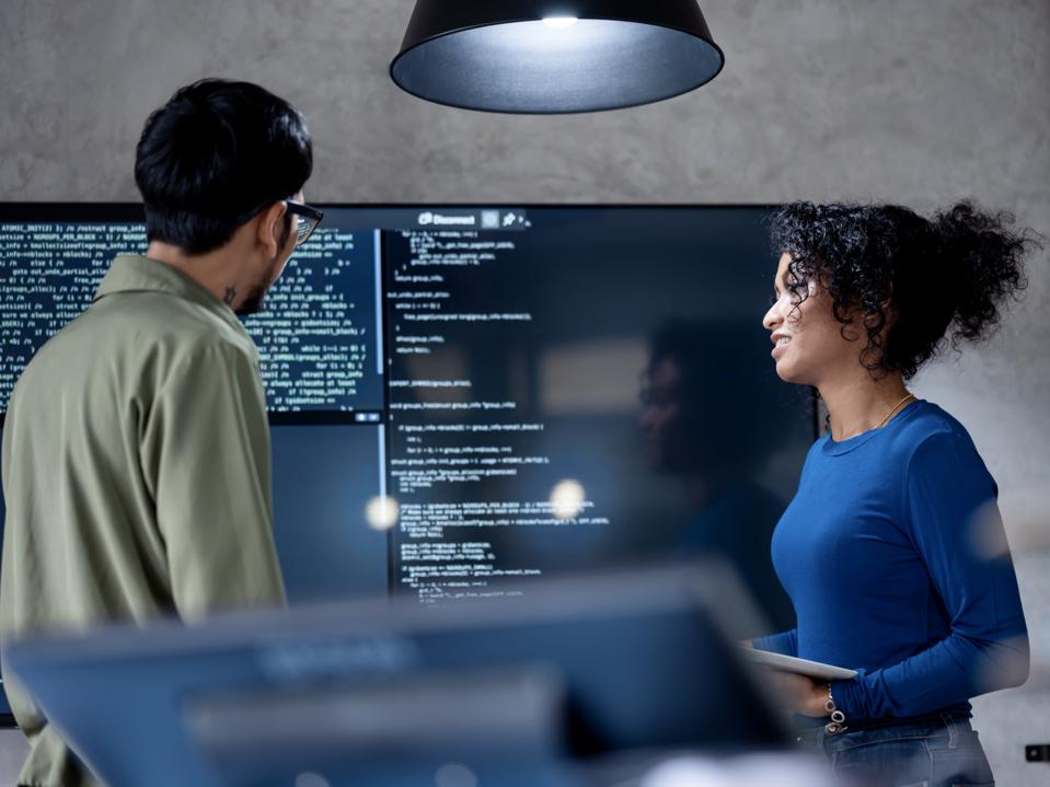 Involve People in Decisions to Improve Performance, Efficiency, and Productivity in Software Development. Diversity of team software developer on a software project discussion to define project timeline in a tech business office.