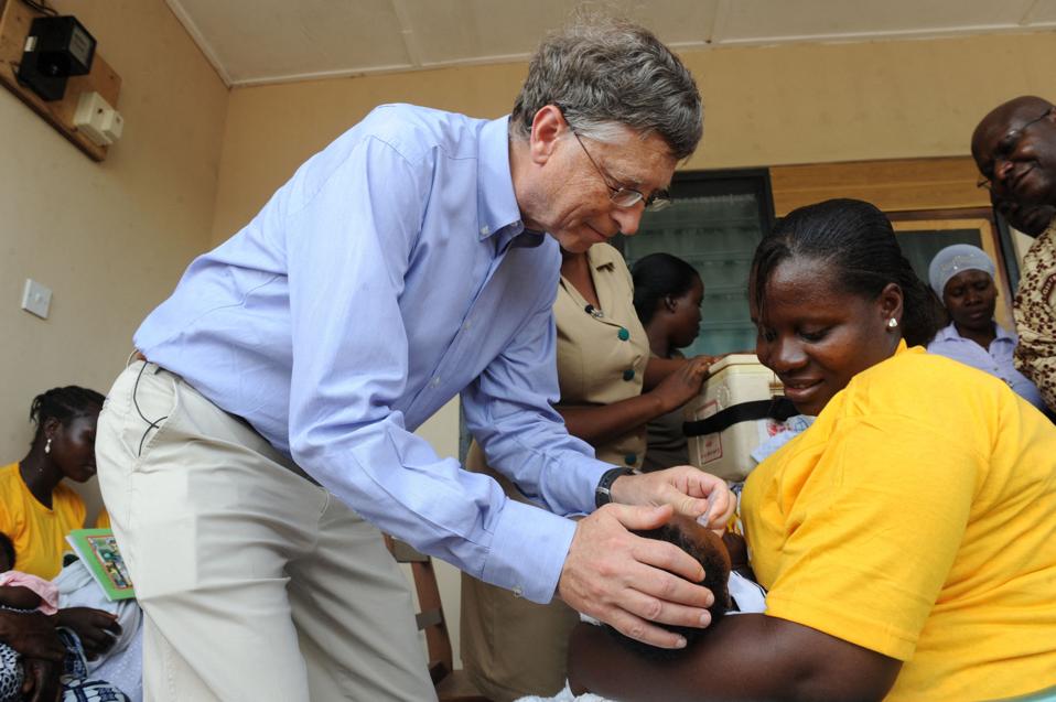 Bill Gates gives to a child a rotavirus vaccine in Ghana.