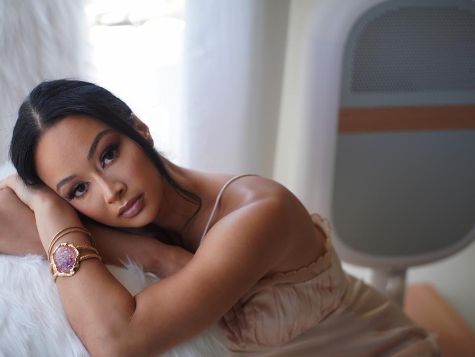 Draya Michele pictured in front of her latest wellness tech investment, Sereniby—a smart air care system designed to support healthier environments for babies and young children.