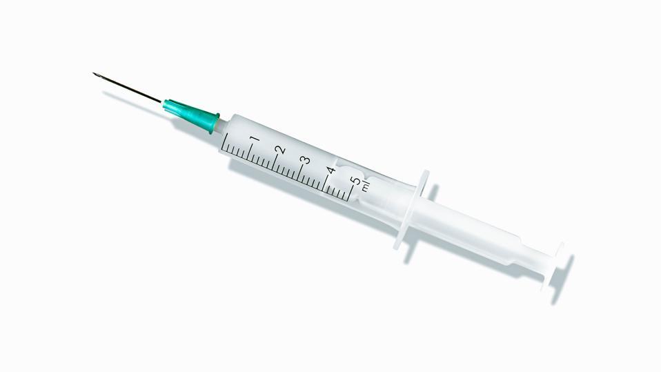 Medical syringes organized in a pattern on white background