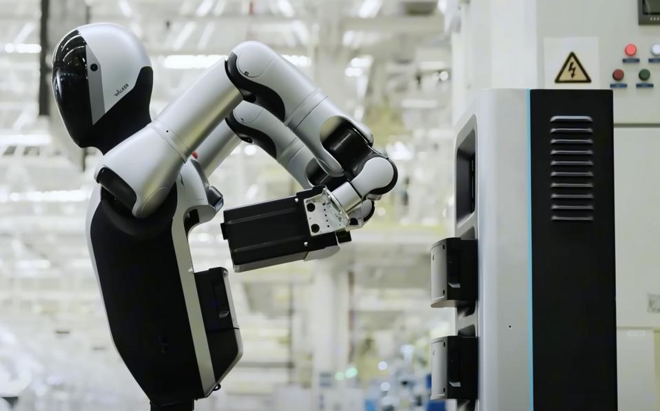 Humanoid robot in front of charging station removes battery from its body with two arms