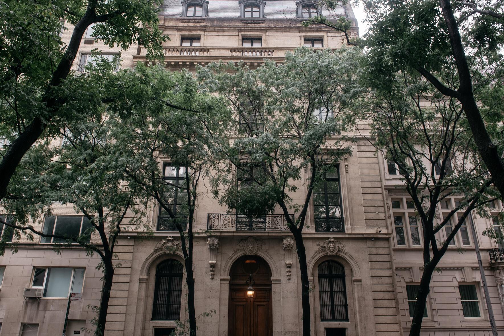 A seven-story neoclassical townhouse on Manhattan's Upper East Side, framed by trees, formerly owned by Jeffrey Epstein.