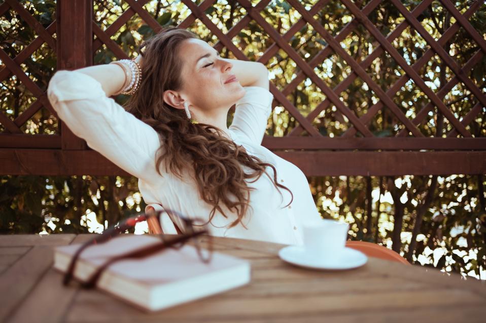 A shopper relaxes with a coffee and a book 
