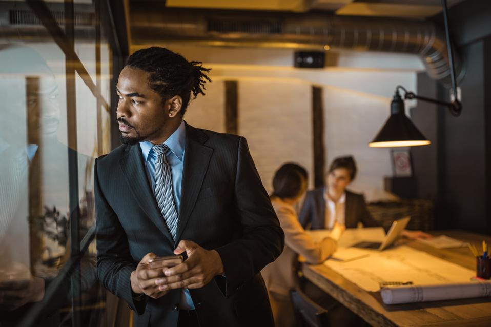 Businessman, architect working late in the office