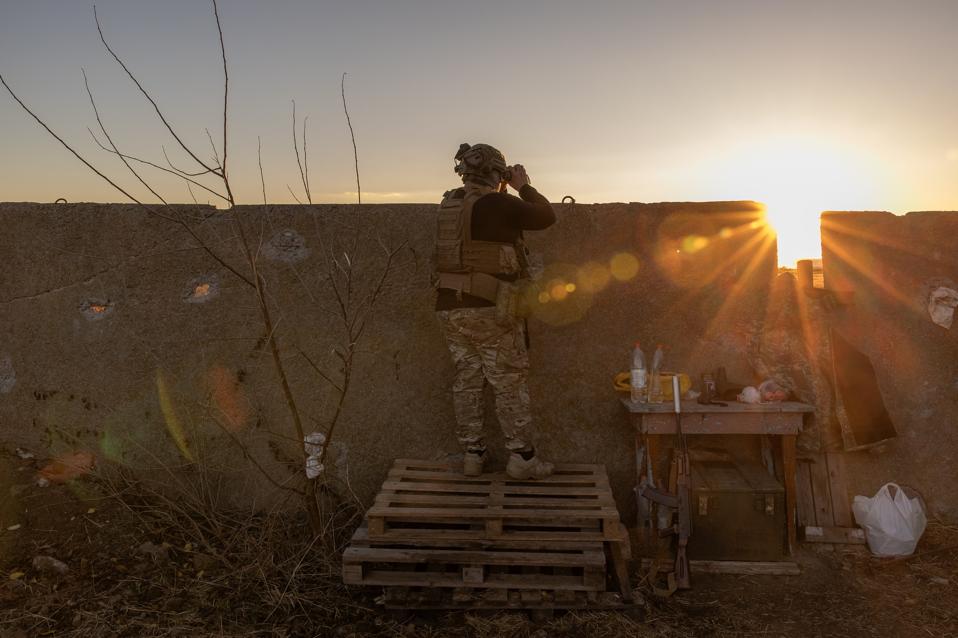 Ukrainian serviceman watches for Russian activity on the Dnipro River,