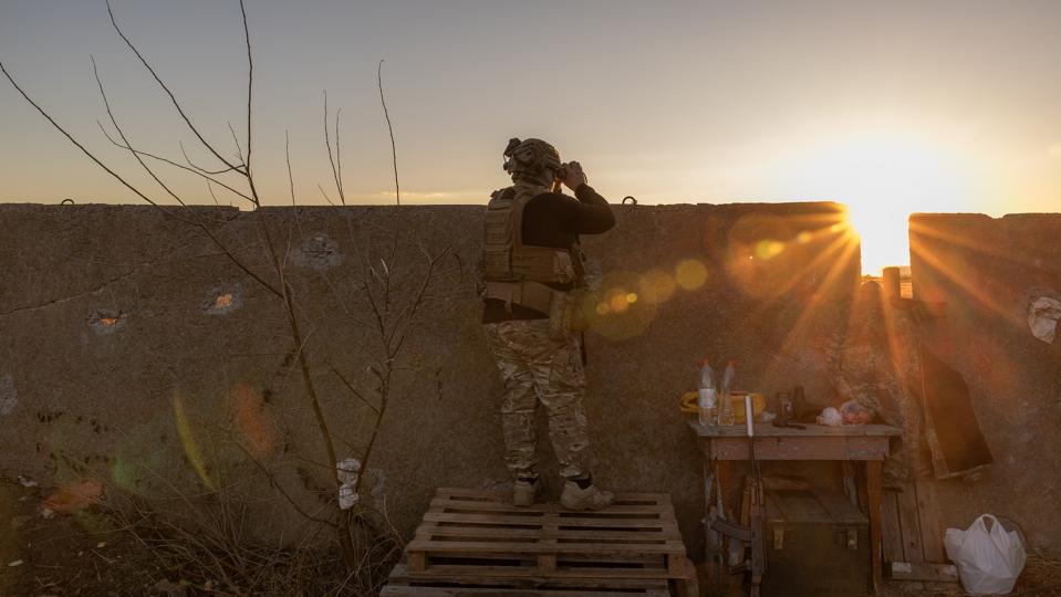 Ukrainian serviceman watches for Russian activity on the Dnipro River,