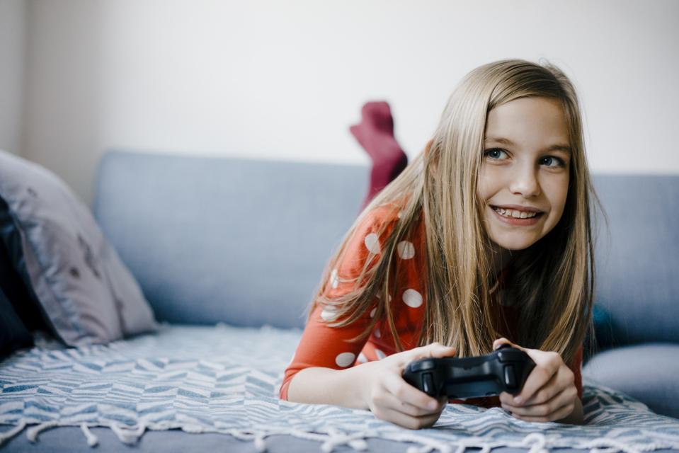 Happy girl playing video game at home