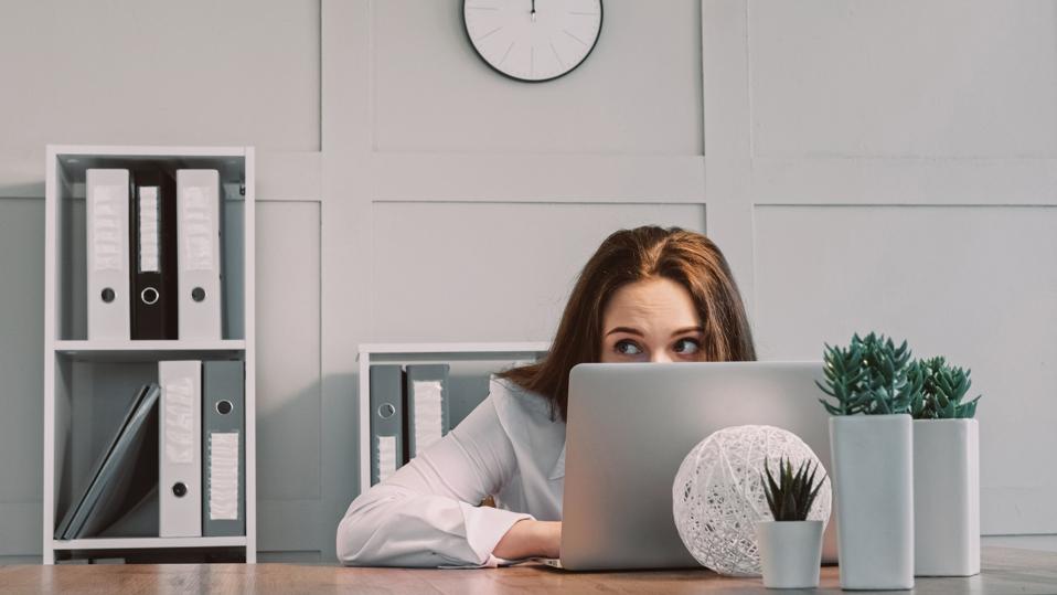 Professional woman using ChatGPT at work to increase productivity.
