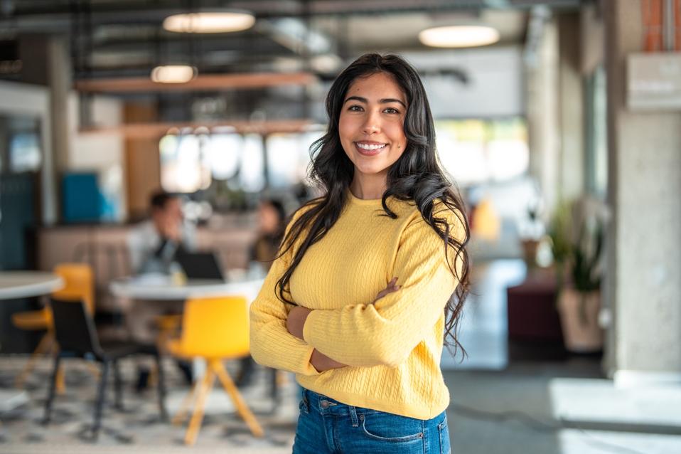 Confident Hispanic Woman in Modern Office Space