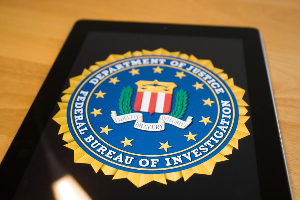 FBI shield seen on a smartphone.