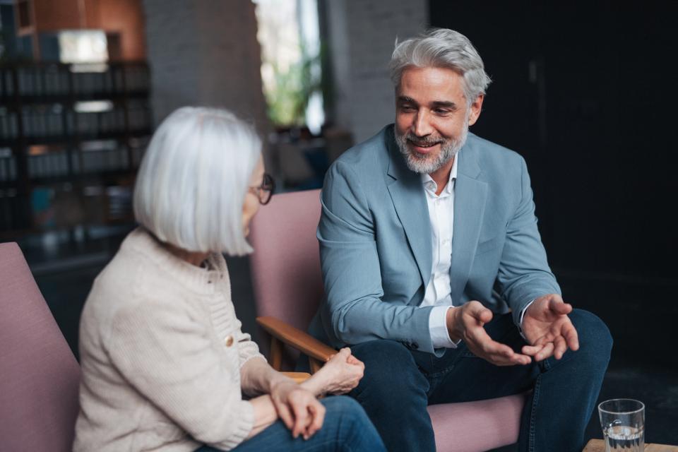 Workplace mental health coaching for manager. Mental health coach helping to navigate stress, anxiety and manage work life balance for female worker.