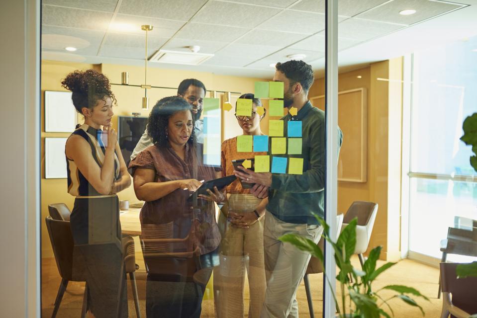 Diverse group brainstorming ideas in modern office space