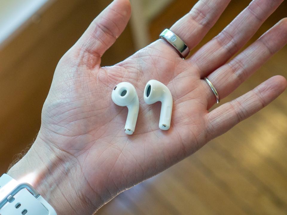 The Apple AirPods Pro 2 and the Apple AirPods 4 held in a hand