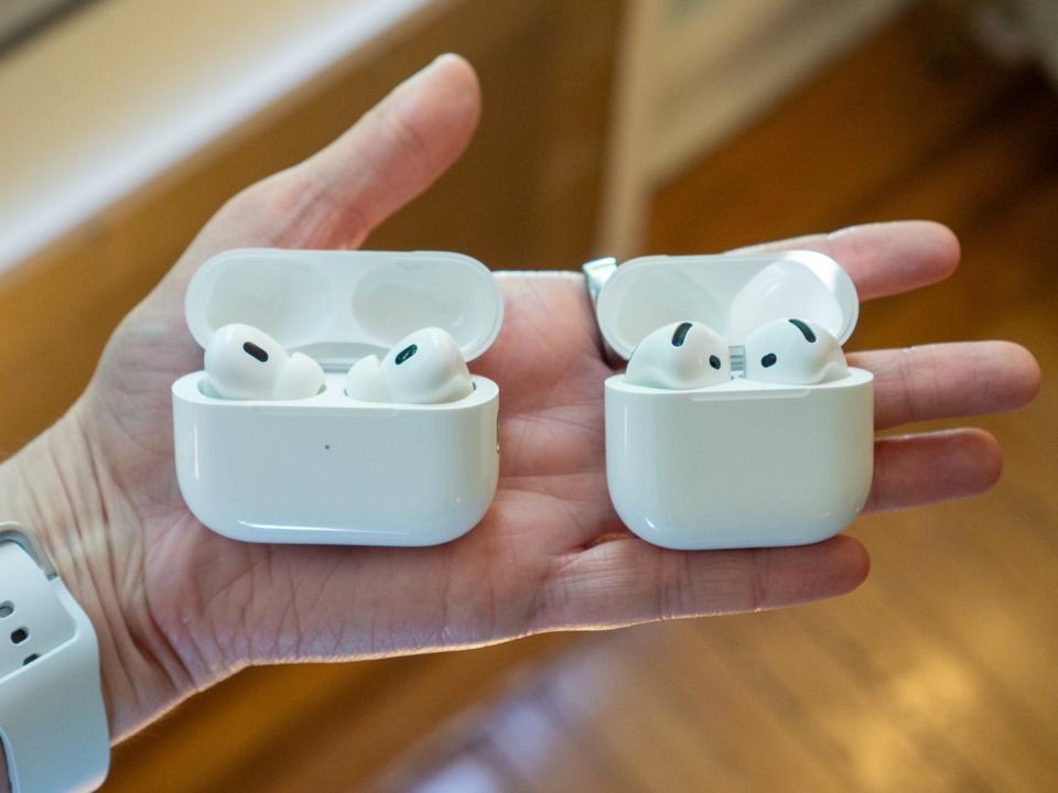 The AirPods Pro 2 case and the AirPods 4 case held in a hand
