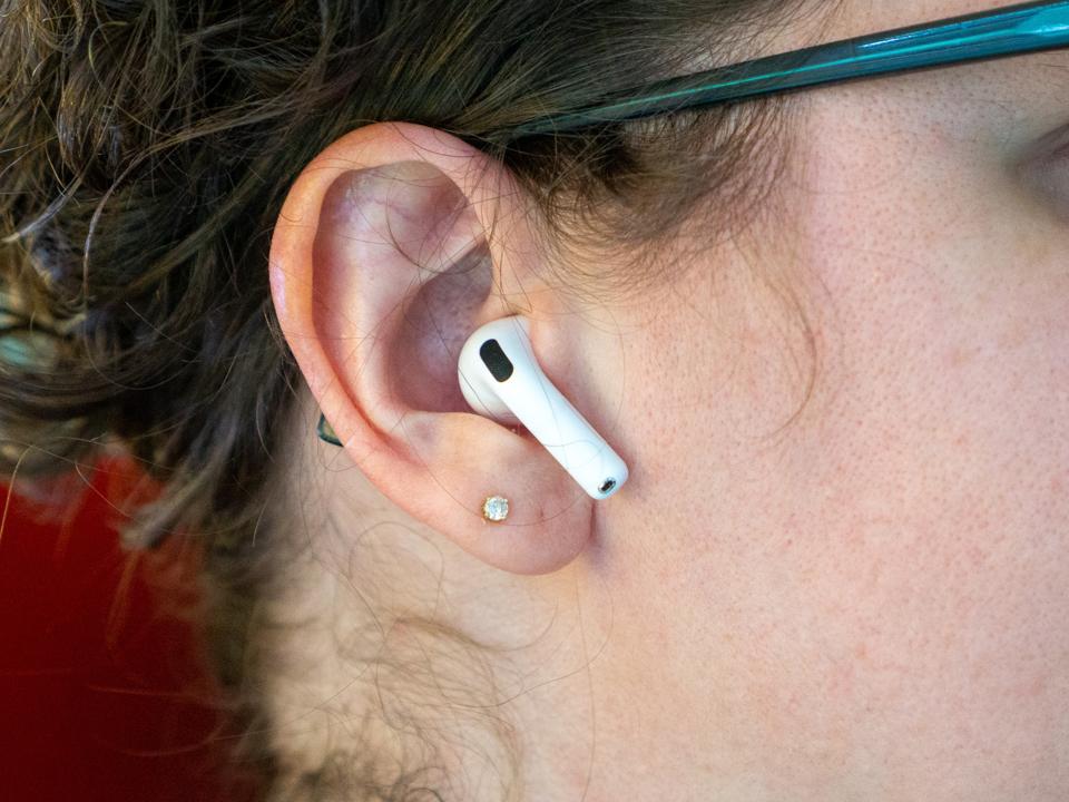 An AirPod 4 in an ear.