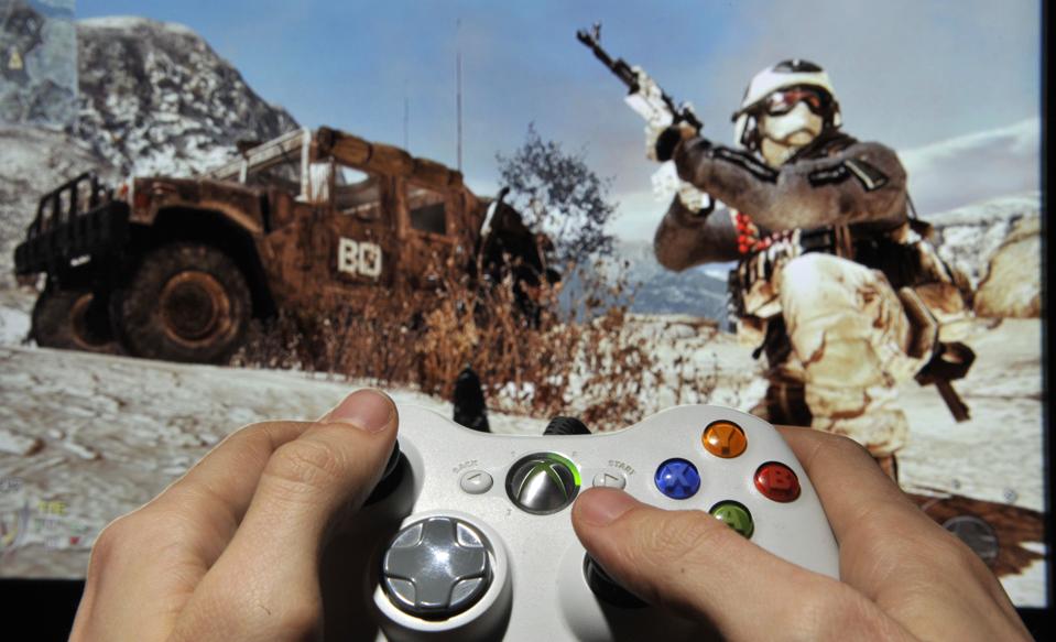 A person plays Call of Duty on an Xbox 360. 