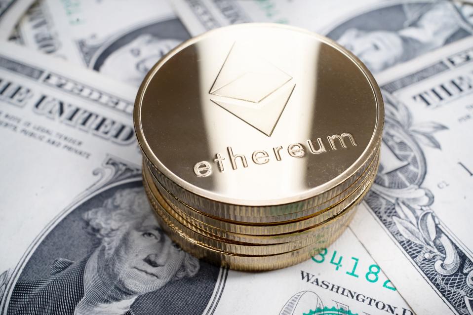 Stack of Ethereum (ETH) coins on top of dollar bills 