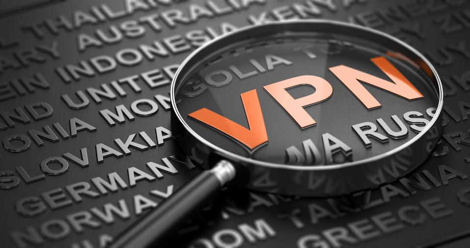 Words cloud over black background with focus on the accronym vpn witten in orange letters and a magnifying glass. 