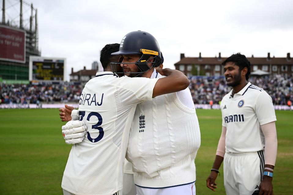 Mohammed Siraj consoles England's Chris Woakes after the fifth Test match at the Oval.