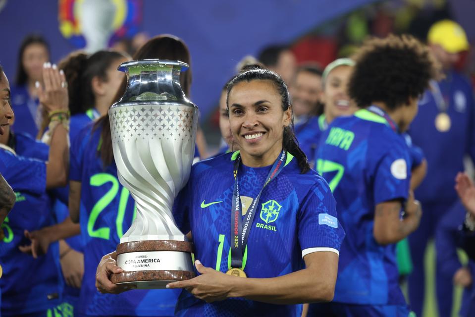 Marta posing with the Copa América trophy.