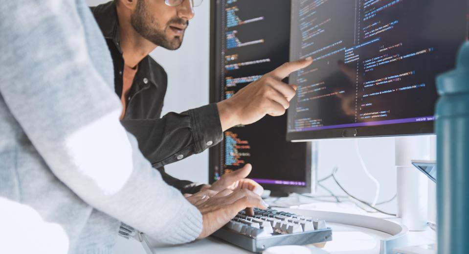 Hispanic Latin American couple, software engineer developer use computer, work on program coding together at home office. Programming language development technology, freelance job concept. Close up