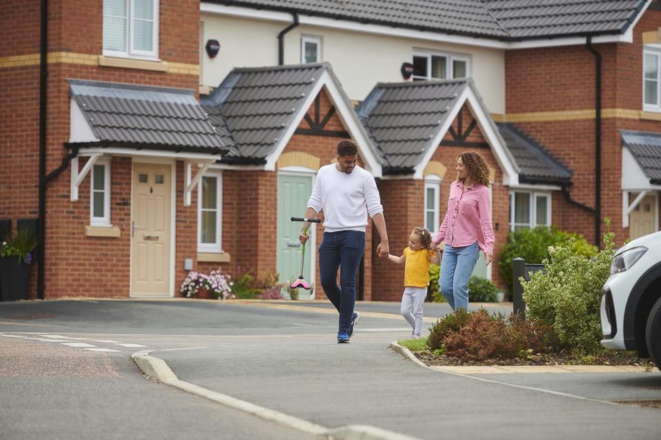family walking through the housing development