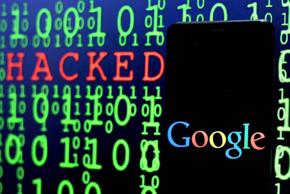 Google logo seen displayed on a Smartphone with the word hacked in the background. 