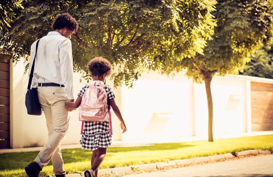 Working dad and young daughter heading back to school. 