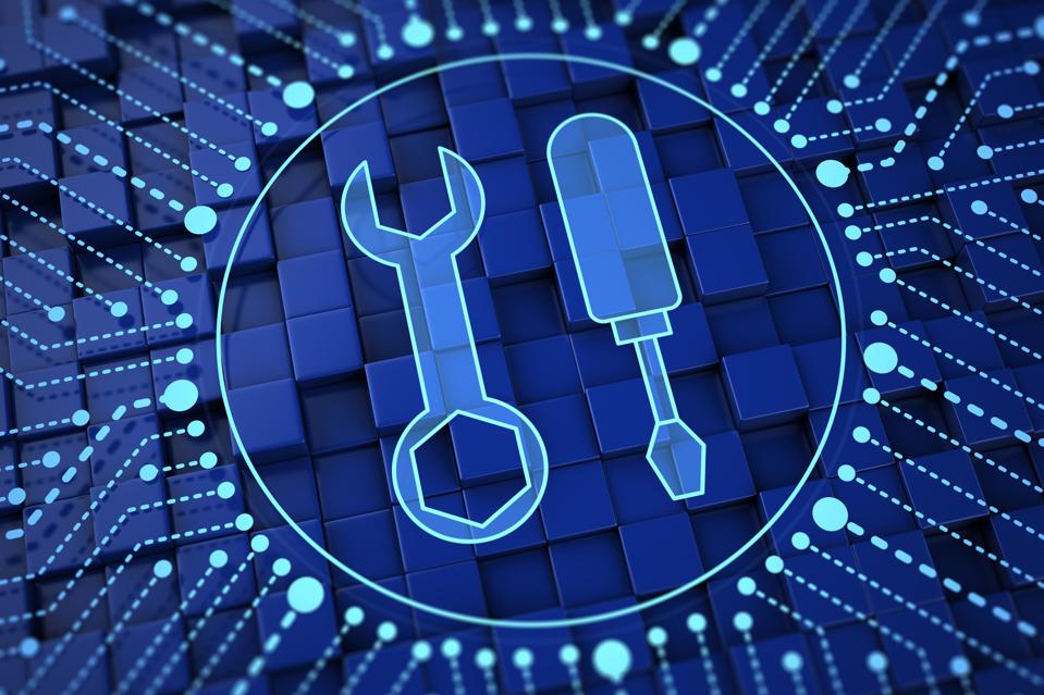 Digital illustration of blue background with dots forming circle. In the center are the outlines of a wrench and screwdriver. Tech hardware concept.