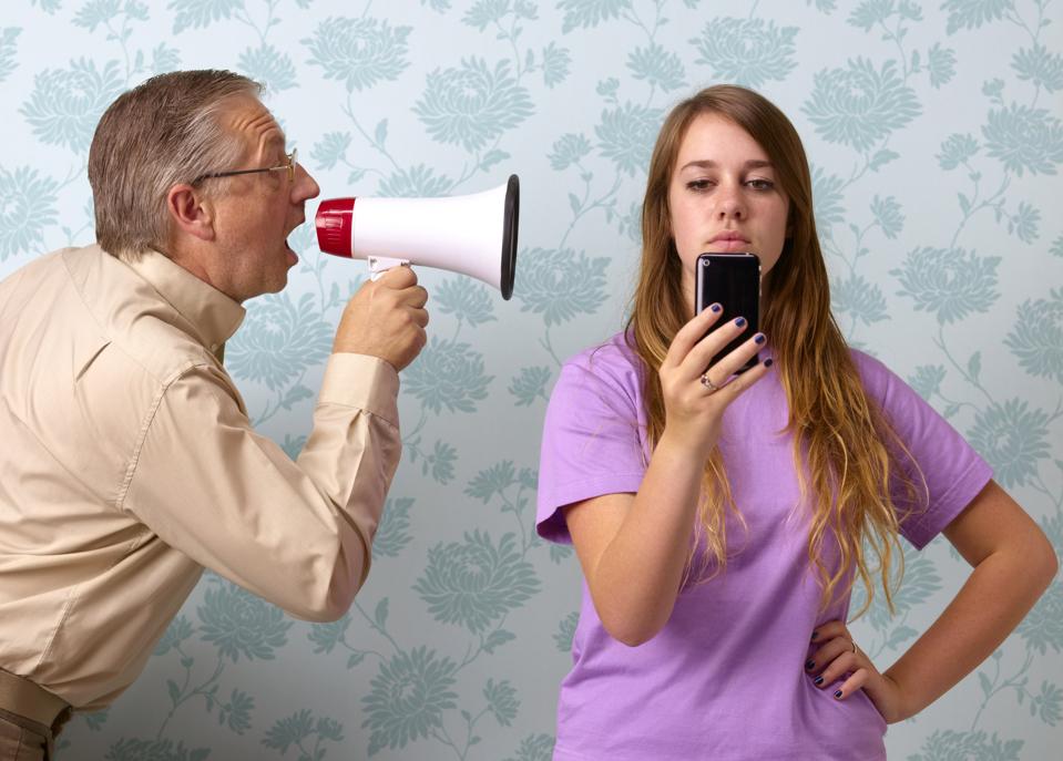 Father shouting at daughter texting