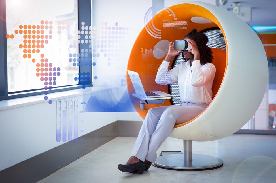 Female employee with laptop and virtual statistic graphics