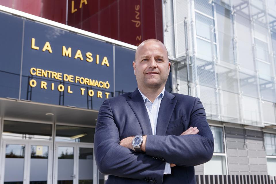 Ex-Barcelona director Xavier Vilajoana with arms folded in front of Barcelona's La Masia.