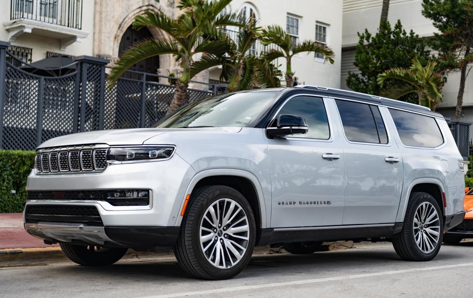 Jeep Grand Wagoneer 2024 SUV car. Luxury SUV car of Grand Wagoneer. Car of Grand Wagoneer parked outdoor. Grey Grand Wagoneer, side view.