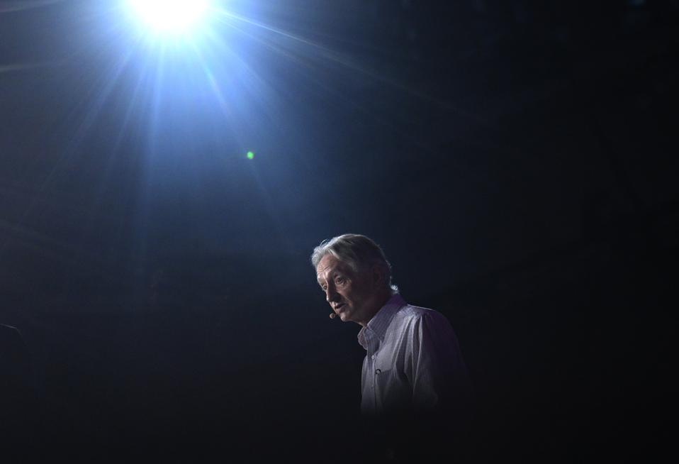 Geoffrey Hinton illuminated in dark room