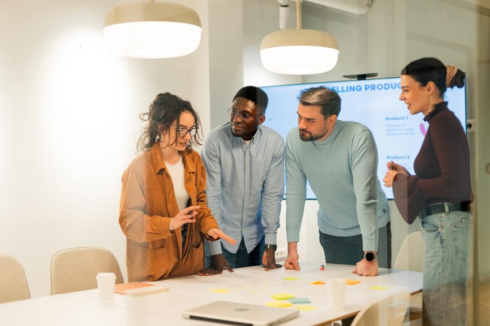 Product design team in meeting, reviewing feature ideas. MVP design