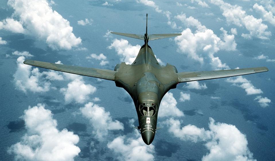 A B-1B aircraft passes over the ocean...