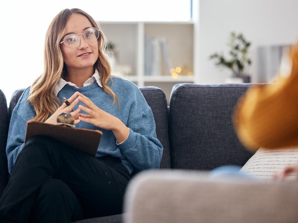 Counseling, therapy and woman therapist talking to client in a consultation or psychology conversation for mental health. Communication, support and professional Psychologist help person with advice