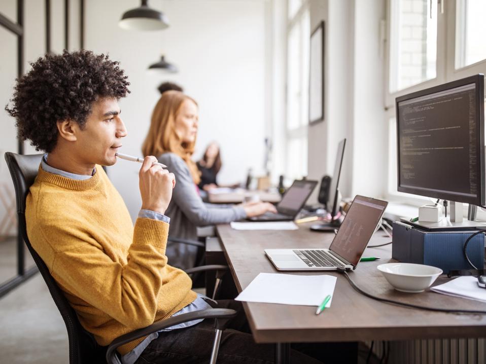 Computer programmer working over new software in office